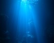 © jancukers - Sunbeams penetrate deep ocean, illuminating dark underwater cavern.