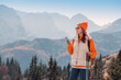 © EdNurg - Young woman hiker using smartphone enjoying the autumn mountain landscape