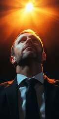 Canvas Print - a man in a suit is looking up at a light