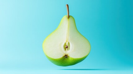Poster - Halved green pear levitating against a light blue background.
