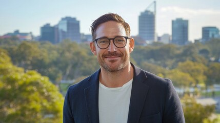 Poster - Smiling man in glasses, city background.