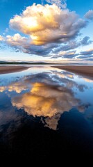 Wall Mural - A large cloud is reflected in the water of a beach