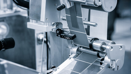 Poster - Fragment of the conveyor of sticking labeling machine. Abstract industrial background.
