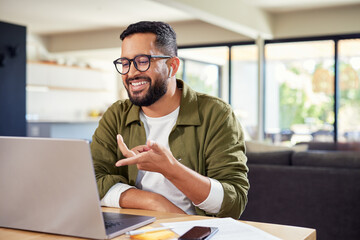 Hispanic man speaking on video call with laptop at home