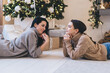 © BullRun - Positive young women relaxing on floor during Xmas holidays