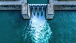 © Gibster - Flood barrier. Aerial view of a dam releasing water into a river, showcasing engineering and nature's interaction.