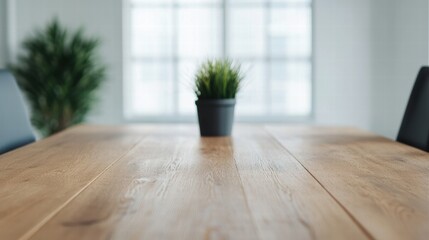 Poster - Wooden table with small potted plant in focus, blurred background with natural light