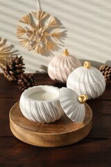 Wall Mural - Soy wax candles and cones on wooden table. Beautiful christmas decor