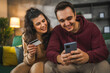 © Miljan Živković - adult happy couple man and woman shopping online hold credit card