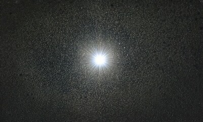Wall Mural - A bright star surrounded by countless other stars in a deep space image.
