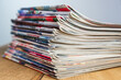 © Andrzej - A pile of colorful magazines lying on wooden table