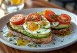 © ANUAR - Deliciously Crafted Avocado Toast with Poached Eggs and Cherry Tomatoes Served on a Plate, Ideal for Breakfast or Brunch in a Trendy Cafe Setting