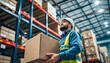 © Rafail - Warehouse worker carrying box in distribution center