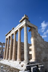 Wall Mural - Ancient Greek columns of the Erechtheion under a clear blue sky on the Acropolis in Athens, Greece