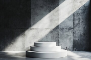 Aufkleber - Three-tiered white podium against a textured concrete wall, illuminated by sunlight.