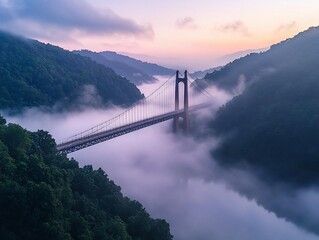 Poster - Suspension bridge above misty valley at sunrise.