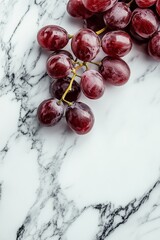 Wall Mural - Fresh red grapes on a marble surface showcasing their vibrant color and smooth texture