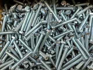Aufkleber - Metallic bolts scattered across a workshop surface at mid-day
