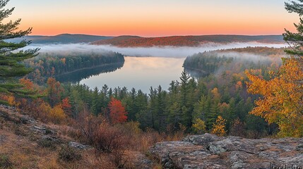 Aufkleber - Panoramic view of a serene lake nestled in an autumnal forest, shrouded in morning mist, at sunrise.