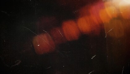 Wall Mural - abstract cinematic bokeh texture with warm red and orange light flares on a black background, vintag