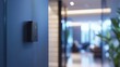 © Justlight - Modern access control system with nfc sensor lighting up on a blue wall in a blurred office environment, enhancing security and convenience