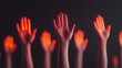 © Peter@studio5 - A group of raised hands illuminated with a red glow against a dark background, symbolizing unity, support, or a call to action.