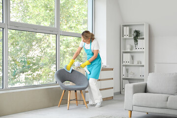 Poster - Female janitor cleaning armchair in office