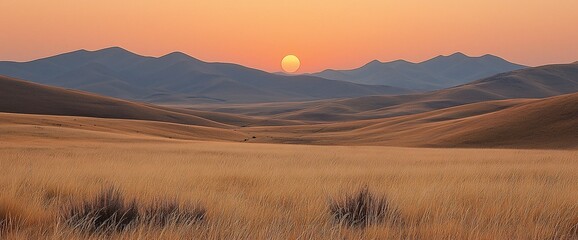 Poster - Sunset over golden grasslands and distant mountains.