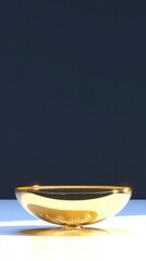 Poster - A shiny golden bowl set against a dark background, emphasizing its reflective surface.