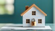 © Arthur Constantine - Miniature house model with a padlock on paperwork representing home security and protection for residential properties