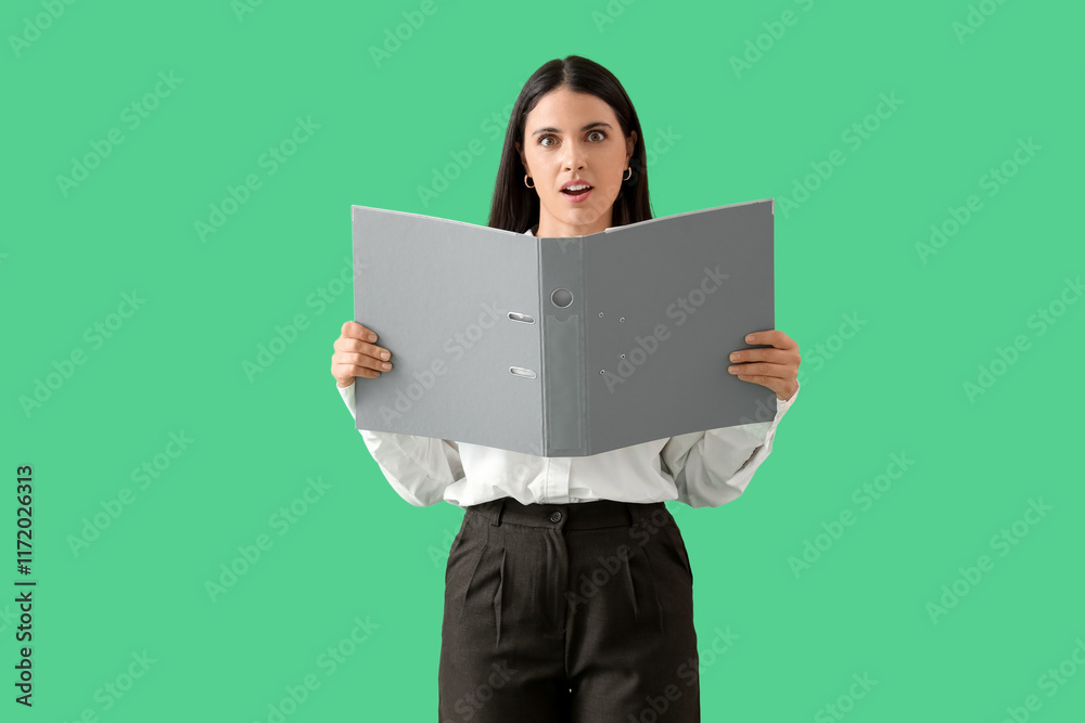 Shocked businesswoman with folders on green background