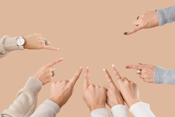 Wall Mural - Many hands pointing at something on beige background