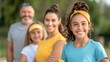 © Vilaysack - A cheerful family poses together outdoors, showcasing joy and connection in vibrant attire against a natural background.