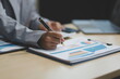© Kansuda - Business Documents, Auditor businesswoman checking searching document legal prepare paperwork or report for analysis TAX time,accountant Documents data contract partner deal in workplace office