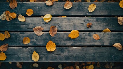Poster - Autumn leaves scattered on a rustic wooden table creating a cozy seasonal atmosphere in nature and home decor.