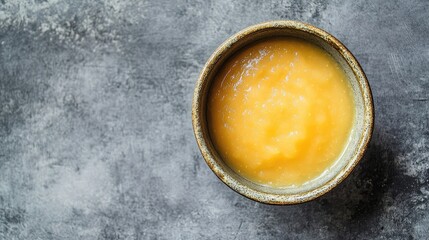 Aufkleber - Overhead shot of a rustic bowl filled with creamy applesauce on a textured gray background ideal for food related content.