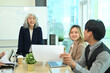 © Prathankarnpap - Group of professionals businesspeople collaborating on a marketing strategy in a modern office