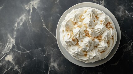 Poster - Overhead view of a traditional pavlova dessert topped with whipped cream and meringue swirls on a marble background