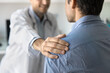© fizkes - Cropped shot of positive sympathetic doctor touching shoulder of man, congratulating patient on getting better, good examination results, successful treatment, giving support, sympathy