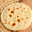 © Rebecca - indian bread / Chapati / Fulka / Gehu Roti with wheat grains in background. It's a Healthy fiber rich traditional North/South Indian food, selective focus