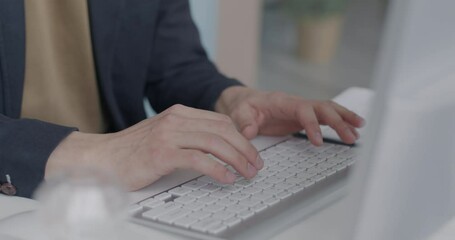 close-up of male hands typing with computer keyboard at desk in office. businessman working online s