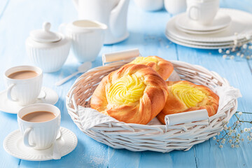 Wall Mural - Sweet cheese yeast bun served with coffee in porcelain..