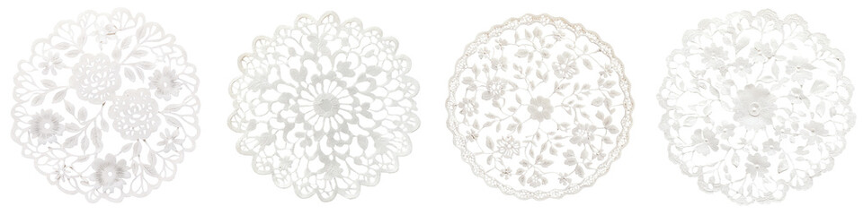 elegant white lace doily patterns forming intricate floral and decorative designs on a plain white b