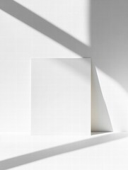 Fototapete - White sheet of paper positioned against a bright background with soft shadows creating an elegant atmosphere. Generative AI
