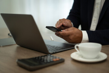 Poster - closeup of hand using smartphone and laptop , coffee in table Freelance work