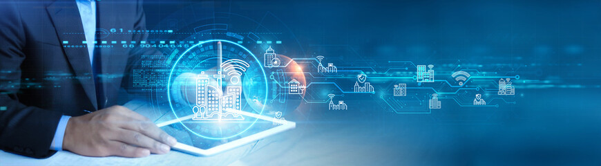 Poster - smart city. businessman holding and using a digital tablet device with smart city infrastructure, co