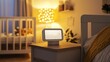 © Matthew - A bedside table with a lamp and a digital display in a cozy, softly lit nursery.