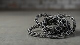 Abstract shot of heavy chains coiled on the industrial floor with copy space