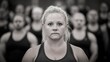 © FarhaStock - Strong Woman in Focus Surrounded by Determined Athletes in Black and White Setting