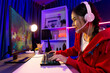 © Summit Art Creations - Host channel of young beautiful Asian gaming streamer playing fighting Moba at battle arena game on pc screen with multiplays, wearing pastel headphone at neon digital light modern room. Stratagem.